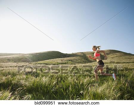 Caucasian woman running in remote field View Large Photo Image Stock Image - Caucasian woman running in remote field. Fotosearch