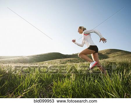 Caucasian woman running in remote field View Large Photo Image Stock Image - Caucasian woman running in remote field. Fotosearch