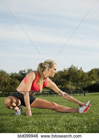 Caucasian woman stretching before exercise View Large Photo Image Stock Photograph - Caucasian woman stretching before exercise. Fotosearch