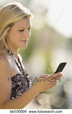 Caucasian woman text messaging on cell phone View Large Photo Image Picture - Caucasian woman text messaging on cell phone. Fotosearch