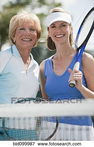 Stock Photo - Caucasian women playing tennis. Fotosearch
