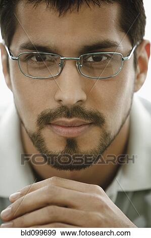 Close up of man with beard wearing eyeglasses View Large Photo Image Stock Photo - Close up of man with beard wearing eyeglasses. Fotosearch