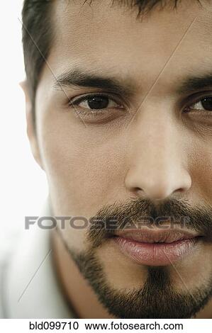 Stock Image - Close up of serious man with beard . Fotosearch