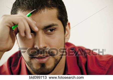 Stock Image - Close up of serious man with beard . Fotosearch