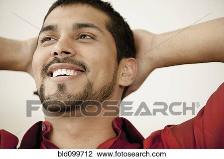 Stock Image - Close up of smiling man with beard . Fotosearch