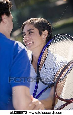 Stock Image - Couple playing tennis. Fotosearch