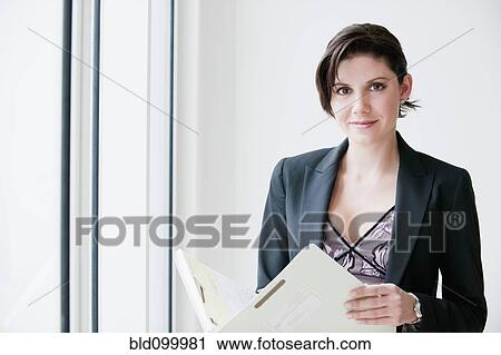 Stock Image - Cuban businesswoman looking at report. Fotosearch