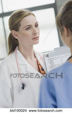 Picture - Doctors talking together in hospital. Fotosearch