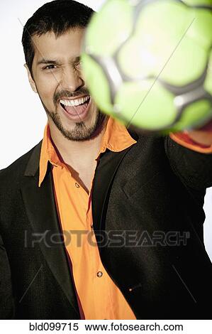 Grinning man holding soccer ball View Large Photo Image Stock Photography - Grinning man holding soccer ball. Fotosearch