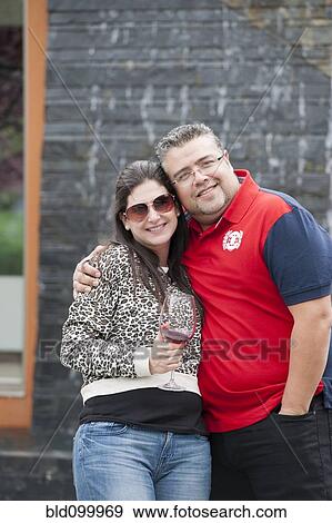 Hispanic couple drinking wine and hugging View Large Photo Image Stock Photo - Hispanic couple drinking wine and hugging. Fotosearch
