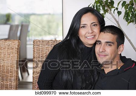 Stock Image - Hispanic mother hugging son. Fotosearch