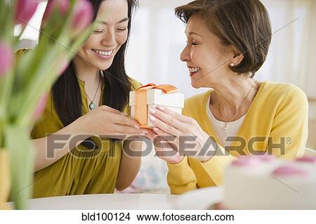 Japanese daughter giving mother gift View Large Photo Image Picture - Japanese daughter giving mother gift. Fotosearch