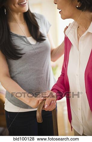 Japanese daughter helping mother walking with cane View Large Photo Image Stock Photo - Japanese daughter helping mother walking with cane. Fotosearch