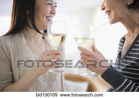 Stock Photo - Japanese mother and daughter drinking white wine. Fotosearch