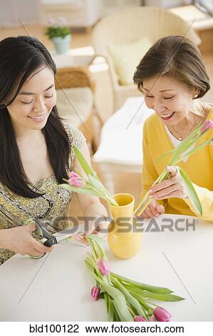 Japanese mother and daughter putting flowers into vase View Large Photo Image Stock Image - Japanese mother and daughter putting flowers into vase. Fotosearch