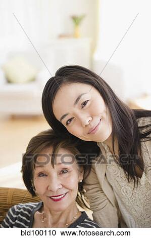 Stock Image - Japanese mother and daughter smiling. Fotosearch