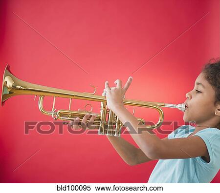 Stock Photography - Mixed race girl playing trumpet. Fotosearch