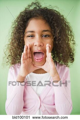 Stock Image - Mixed race girl shouting. Fotosearch