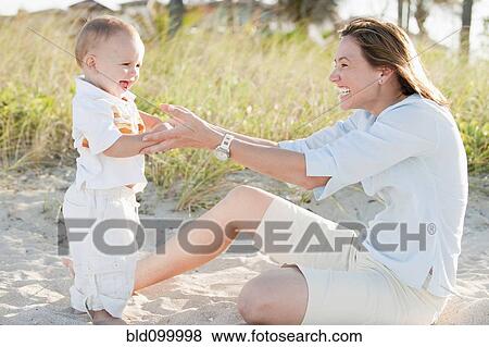 Stock Photo - Mother and son enjoying the beach. Fotosearch