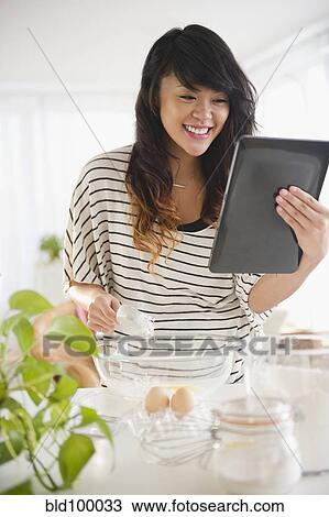 Pacific islander woman baking and using digital tablet View Large Photo Image Stock Image - Pacific islander woman baking and using digital tablet. Fotosearch