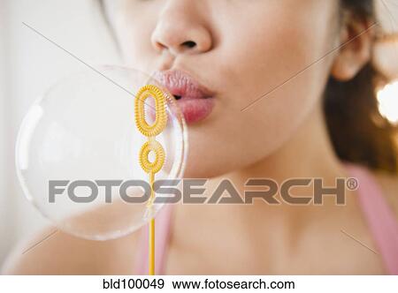 Pacific Islander woman blowing bubble View Large Photo Image Stock Photo - Pacific Islander woman blowing bubble. Fotosearch