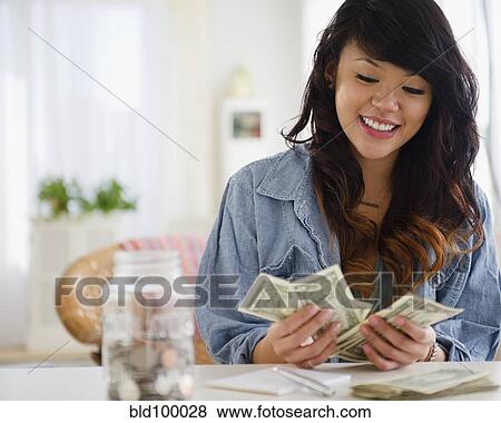 Pacific Islander woman counting money View Large Photo Image Stock Photo - Pacific Islander woman counting money. Fotosearch