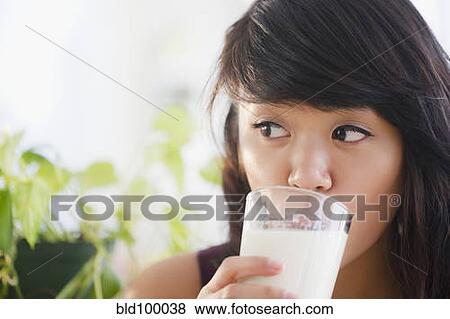 Stock Photo - Pacific Islander woman drinking milk. Fotosearch
