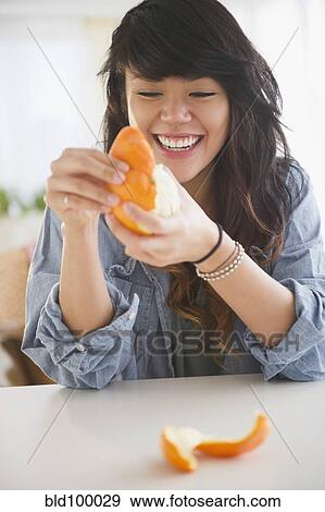 Pacific Islander woman peeling an orange View Large Photo Image Stock Photo - Pacific Islander woman peeling an orange. Fotosearch