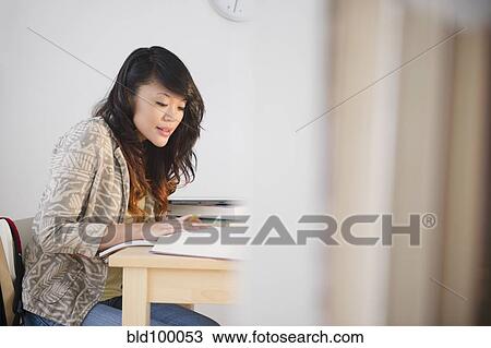 Stock Image - Pacific Islander woman studying. Fotosearch
