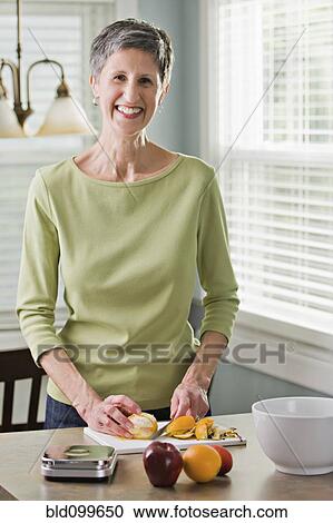 Senior woman cutting fruit View Large Photo Image Stock Image - Senior woman cutting fruit. Fotosearch