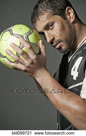 Serious athlete holding soccer ball View Large Photo Image Stock Image - Serious athlete holding soccer ball. Fotosearch