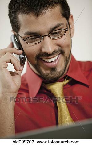 Smiling businessman talking on cell phone View Large Photo Image Stock Photo - Smiling businessman talking on cell phone. Fotosearch