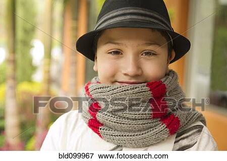 Stock Photo - Smiling Hispanic boy in hat and scarf. Fotosearch
