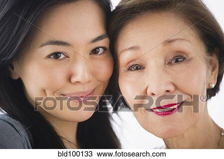 Stock Image - Smiling Japanese mother and daughter. Fotosearch