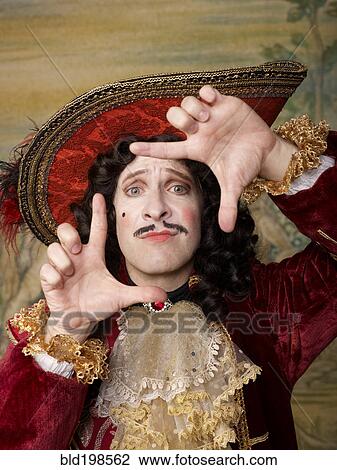 Stock Image - Actor dressed in old-fashioned costume making frame gesture. Fotosearch
