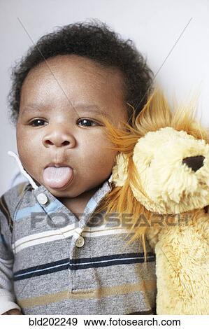 Stock Photo - African American baby sticking out tongue. Fotosearch