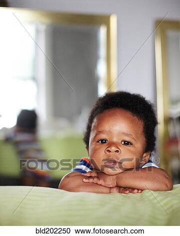 Stock Image - African American baby with arms crossed. Fotosearch