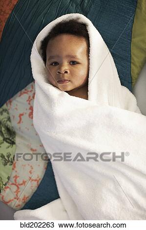 Stock Image - African American baby wrapped in towel. Fotosearch