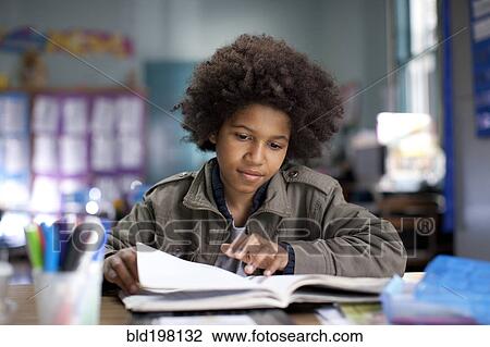 Stock Image - African American boy studying in classroom. Fotosearch