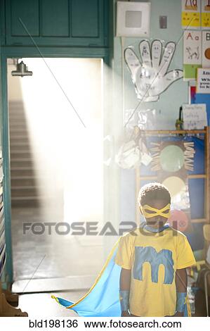 African American boy wearing superhero costume in classroom View Large Photo Image Stock Photograph - African American boy wearing superhero costume in classroom. Fotosearch