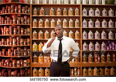 African American businessman talking on cell phone in shop View Large Photo Image Stock Image - African American businessman talking on cell phone in shop. Fotosearch
