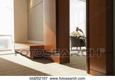Stock Photo - African American businessman talking on cell phone. Fotosearch