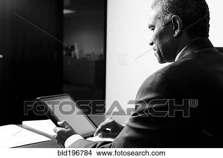 African American businessman using electronic tablet View Large Photo Image Picture - African American businessman using electronic tablet. Fotosearch