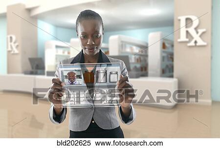 Stock Photography - African American businesswoman using digital display in pharmacy. Fotosearch