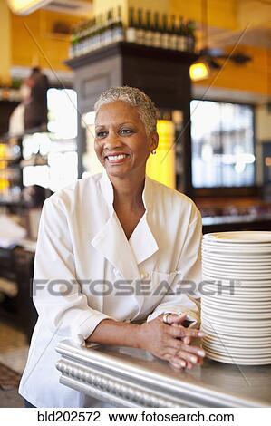 Stock Image - African American chef in cafe. Fotosearch