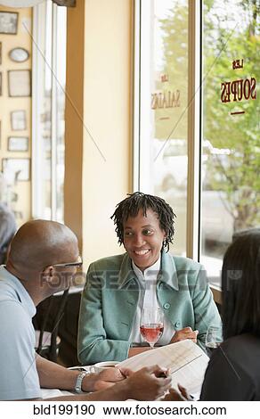 Stock Image - African American co-workers working in restaurant. Fotosearch