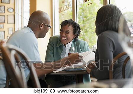 Stock Photo - African American co-workers working in restaurant. Fotosearch