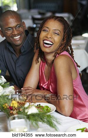 Stock Photography - African American couple having dinner in restaurant. Fotosearch