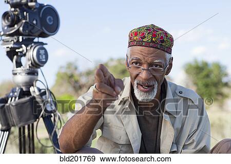 Stock Photo - African American director near film camera. Fotosearch