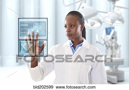 African American doctor looking at digital display in doctor's office View Large Photo Image Stock Photo - African American doctor looking at digital display in doctor's office. Fotosearch